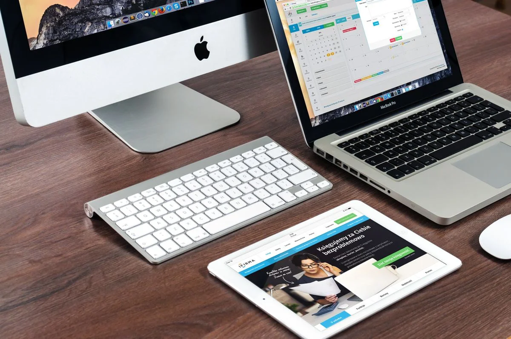 Multiple devices on a wooden desk